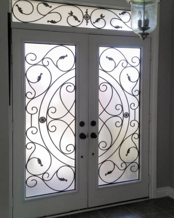 Europa wrought iron inserts in a double door with a transom