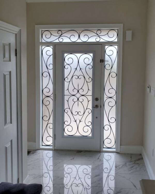Bristol wrought iron inserts in a door with sidelites and a transom