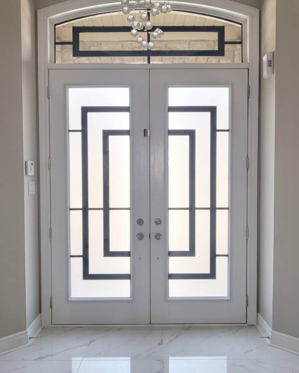Constellation wrought iron inserts in a double door with a transom