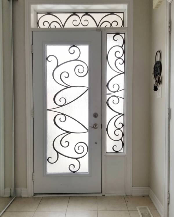 A custom laser cut iron insert with sidelites and a transom
