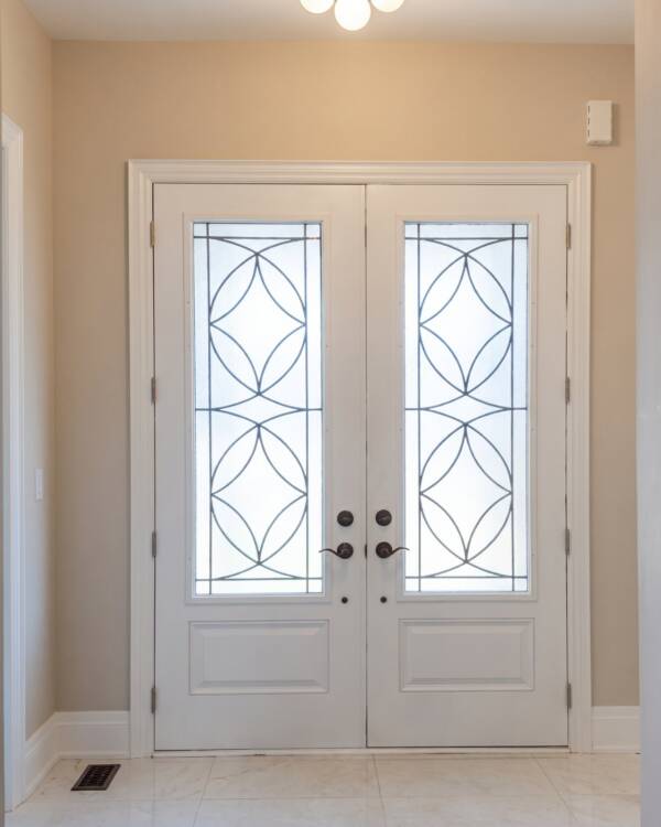 Custom wrought iron inserts in a white double door