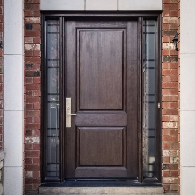 A dark woodgrain door with dark sidelites