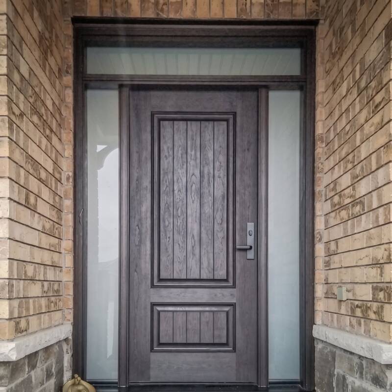 A dark woodgrain door with frosted sidelites and a transom