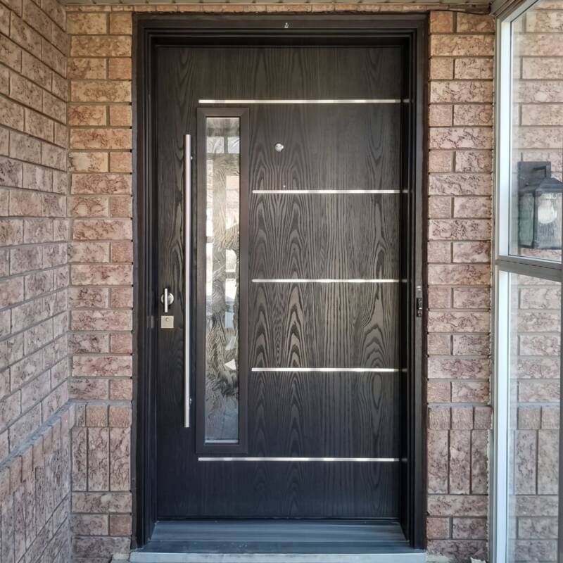 A dark modern door with horizontal metal inlays