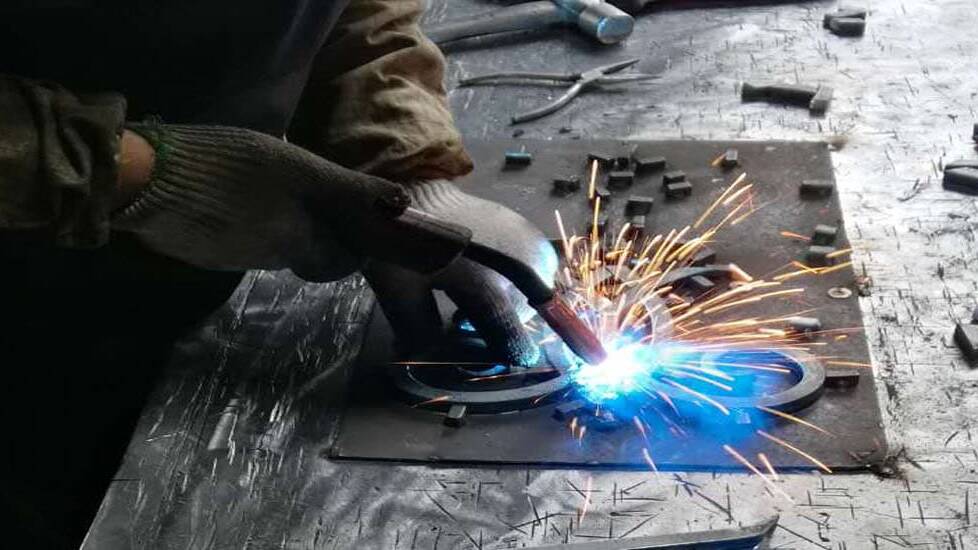 The parts of an iron insert being welded