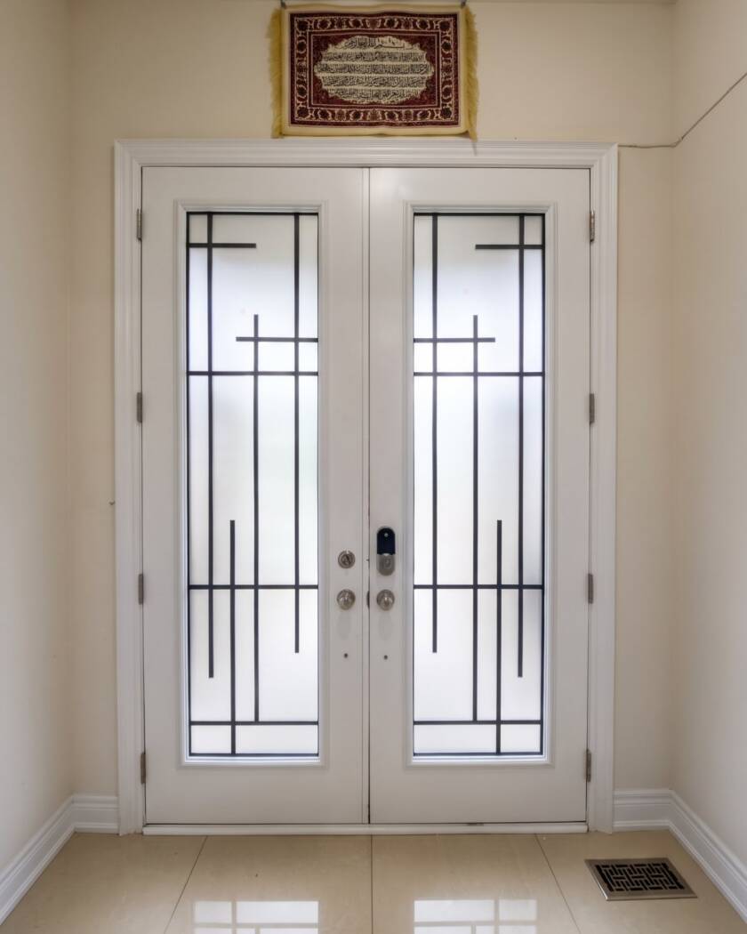 Enigma wrought iron inserts in a white double door