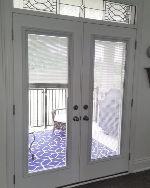 French doors with blinds between the glass, sidelites and transoms