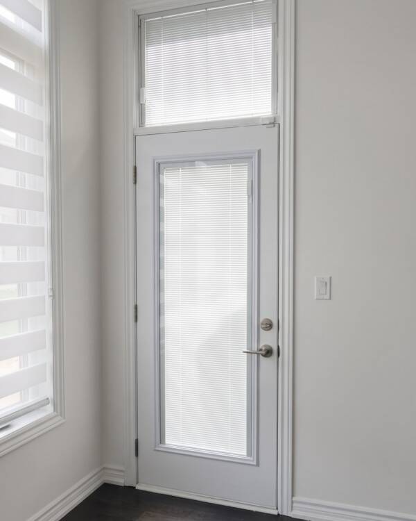 A single door with a custom-size blind insert and a transom