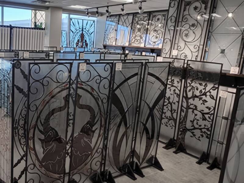 Rows of door inserts on stands in the showroom