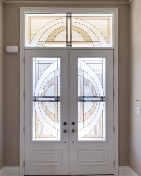 Concerto stained glass inserts in a double door with a transom