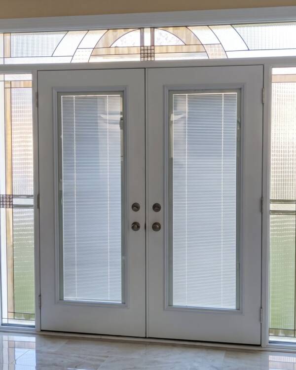 Concerto stained glass inserts in a double door