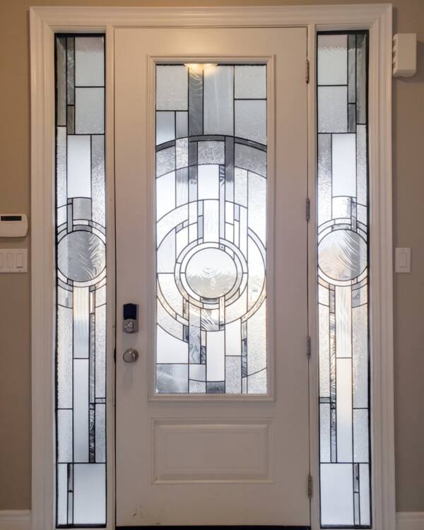 A custom stained glass insert in a front door with sidelites