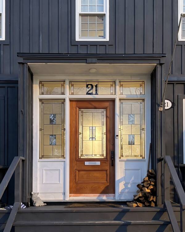 A stained glass insert with the house number, in a front door