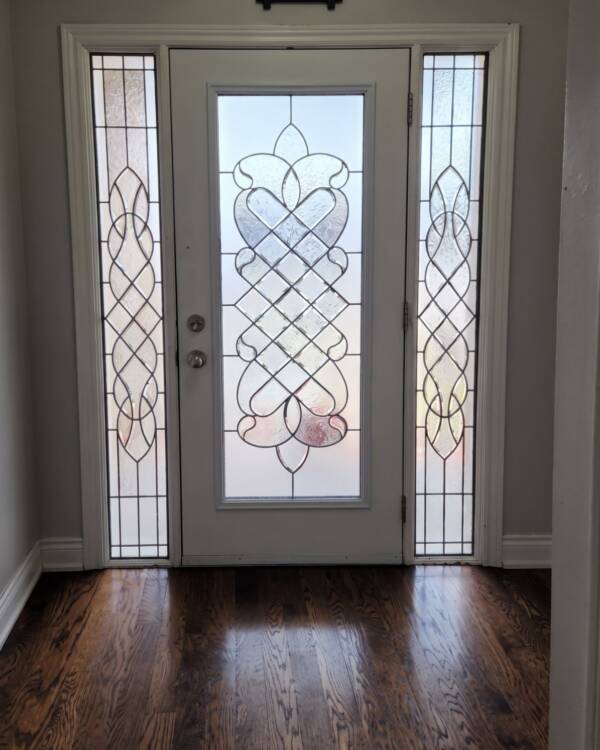 A stained glass insert in a single door with sidelites
